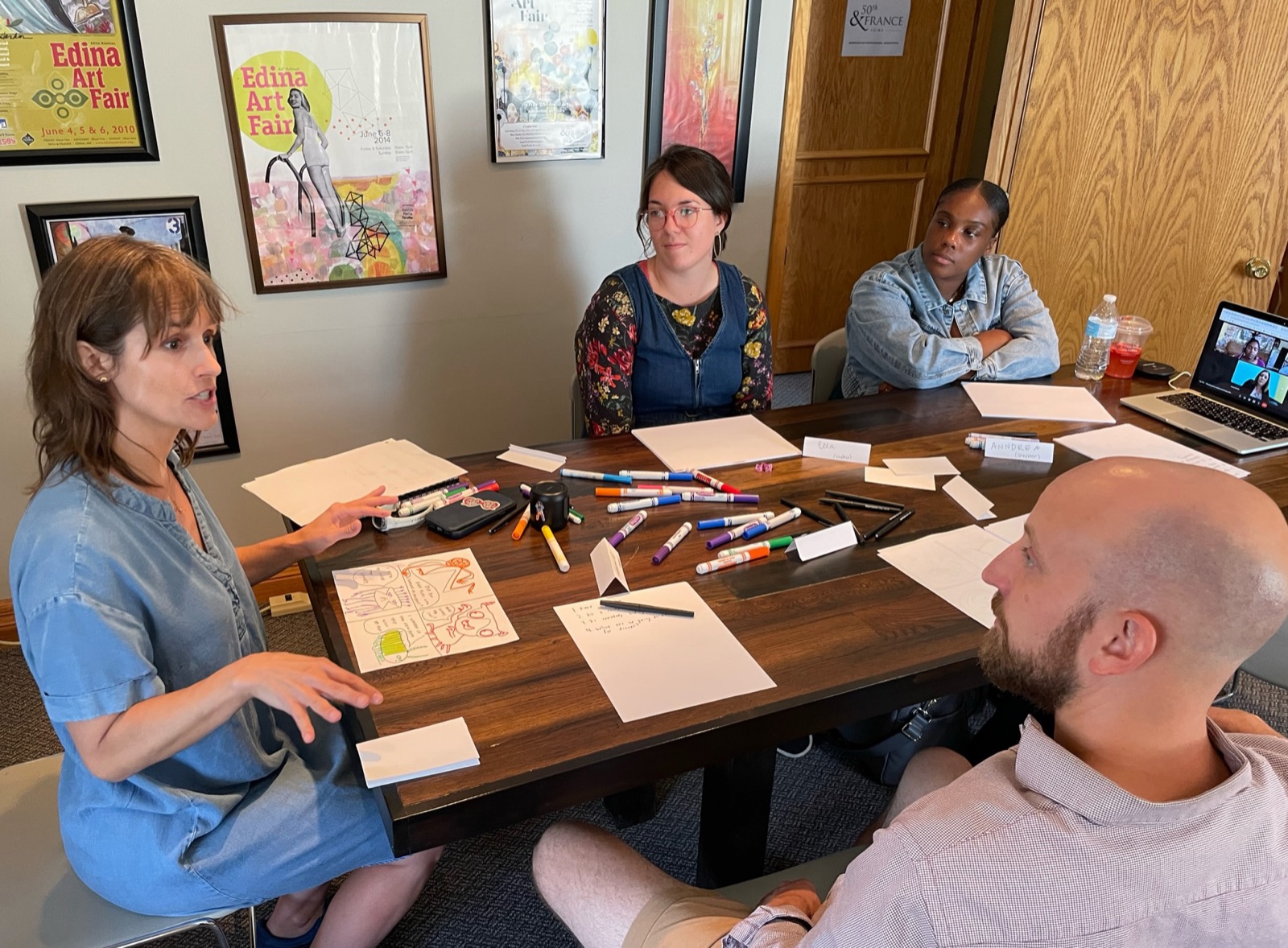Adults drawing together at a workshop table