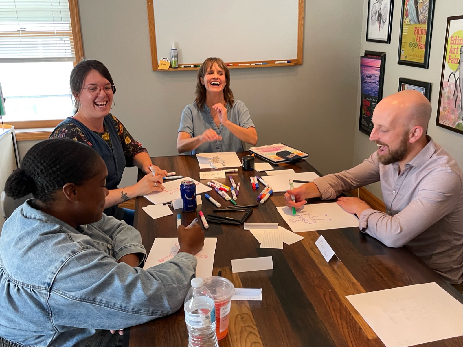 Stephanie Watson leading a small workshop around a table