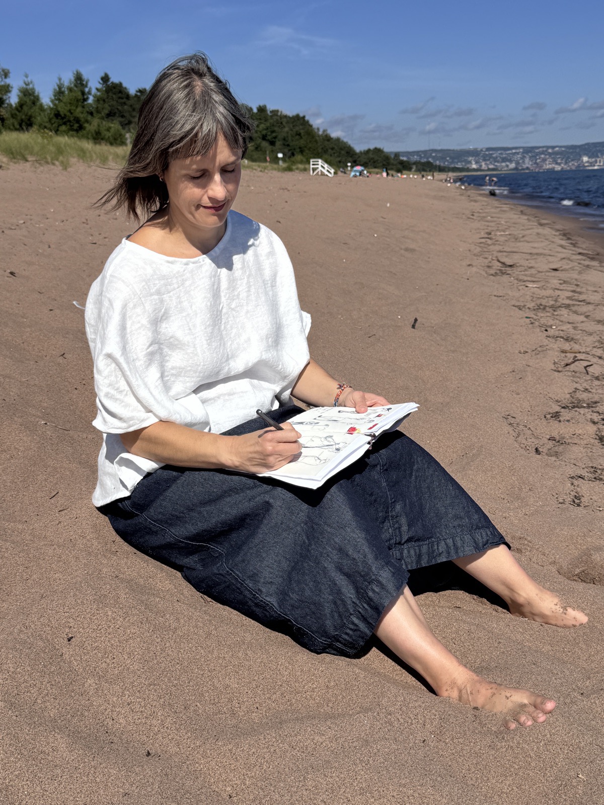 Stephanie Watson sketching on the beach
