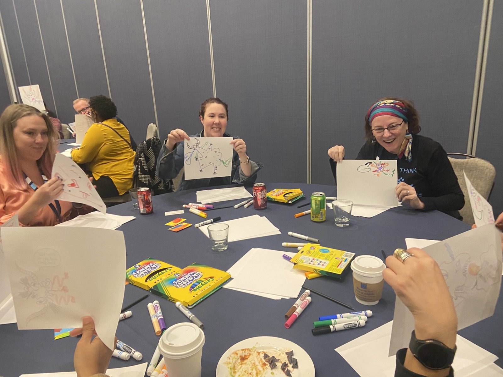Workshop participants holding up their drawings