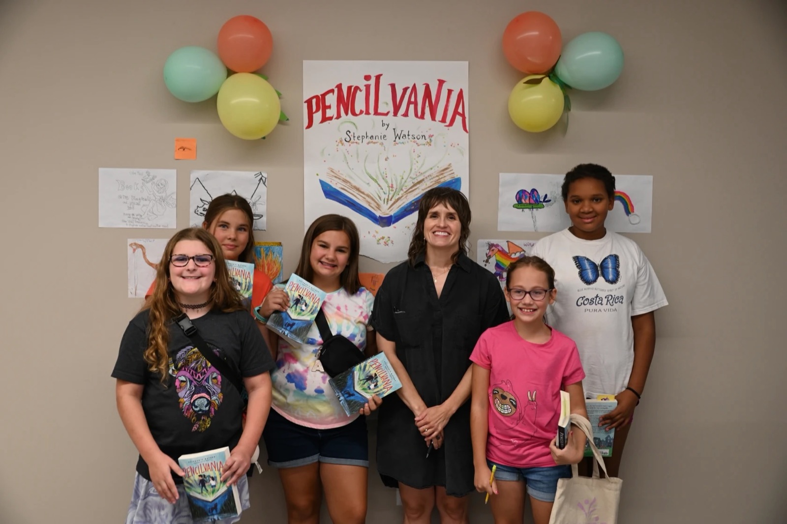 Author Stephanie Watson standing with five kids.